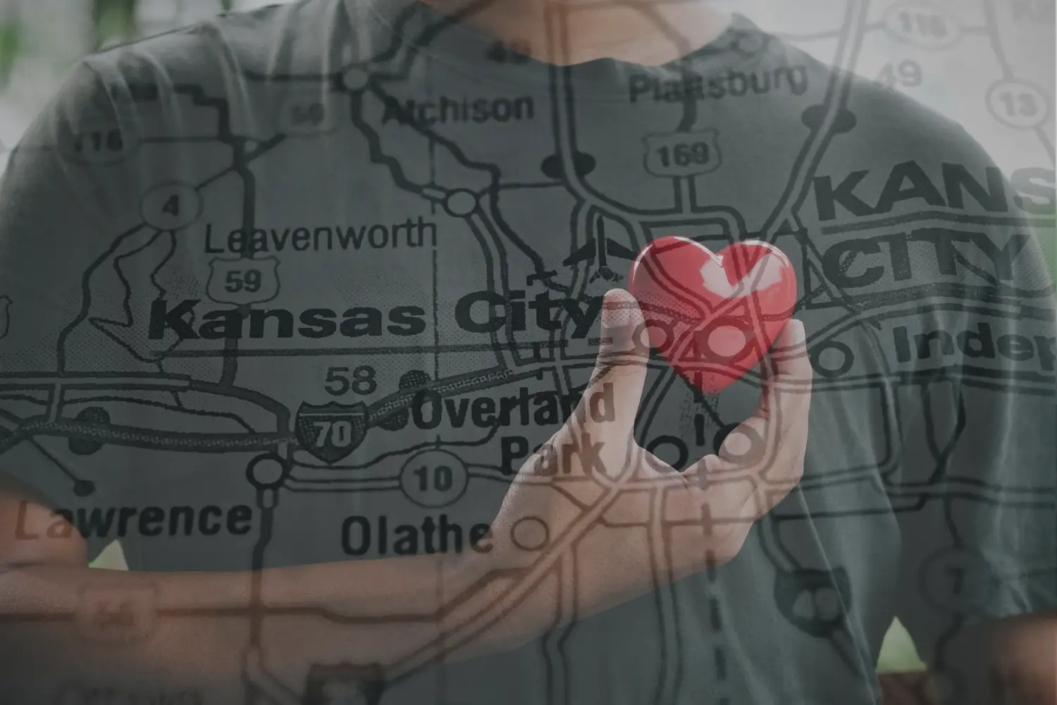 black man holding heart over his chest to represent health coaching in Kansas City